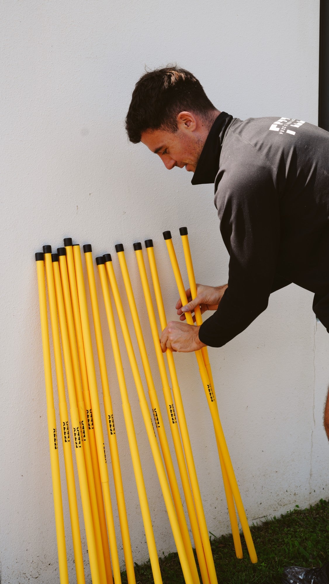 Liam laying out Fezz X safety stair rods